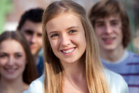 Several adolescents smiling at the camera